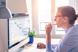 IT project manager reviewing a gantt chart