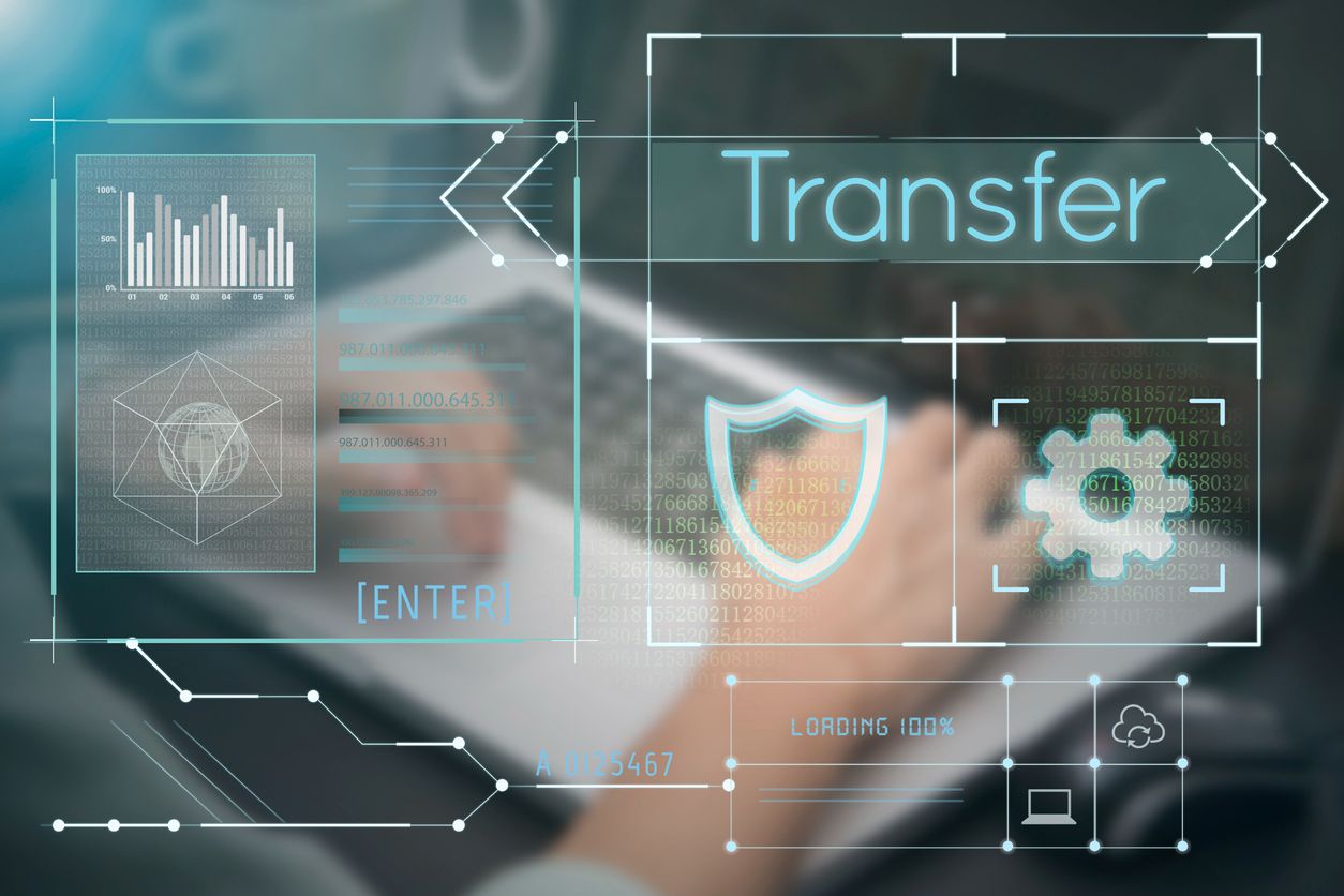 Business hand typing on computer keyboard with Transfer homepage on the screen during data migration